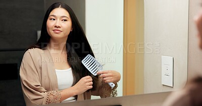 Buy stock photo Mirror, beauty and woman brushing hair in bathroom for grooming, self care or morning routine. Happy, reflection and Asian female person with hairstyle for daily haircare treatment in apartment.