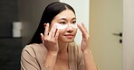 Bathroom, mirror and woman with eye mask for skincare, hydration or self care routine with cosmetics. Reflection, home and Asian person with smile, dermatology and reducing puffiness with patches