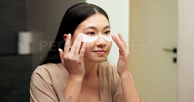 Buy stock photo Bathroom, mirror and woman with eye mask for skincare, hydration or self care routine with cosmetics. Reflection, home and Asian person with smile, dermatology and reducing puffiness with patches