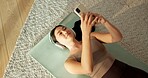 Yoga mat, headphones and Asian woman with phone on floor for music, streaming and social media. Apartment, happy and above of person with cellphone for health app, meditation audio and fitness