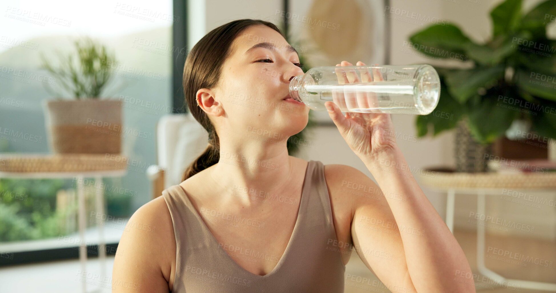 Buy stock photo Yoga, relax and girl drinking water in house for practice break, exercise hydration and thirsty. Self care, asian woman and rest with beverage in living room for fitness nutrition, wellness and detox