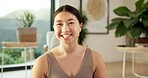 Portrait, woman and smile with yoga in home for holistic practice, exercise rest and self care. Yogi, asian person and happy to relax in living room for fitness break, morning wellness and health