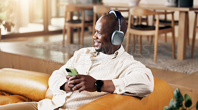 Buy stock photo Music, phone and thinking with black man on sofa in home living room for me time or wellness. Headphones, relax and thoughtful with happy person in apartment for audio, song or sound streaming