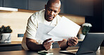 Review, paperwork and man with finance in home for statement balance, utility bills or planning. Budget, laptop and black person with documents for housing expenses, transaction history or check debt