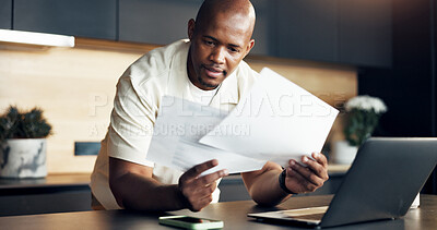 Buy stock photo Review, paperwork and man with finance in home for statement balance, utility bills or planning. Budget, laptop and black person with documents for housing expenses, transaction history or check debt