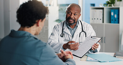 Buy stock photo Healthcare, doctor and man with clipboard, talking and medical appointment for wellness in hospital. Health professional, discussion and explaining diagnosis to person, consultation or help in clinic