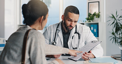 Buy stock photo Healthcare, doctor and man with clipboard, consultation and medical advice for patient or discussion. Health professional, talking and explaining diagnosis to person, pointing and question in clinic