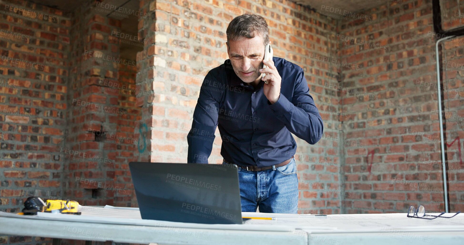 Buy stock photo Man, laptop or architect at site with phone call, contact and schedule review for building progress. Construction, mature foreman and tech for digital floor plan, online communication and mobile chat