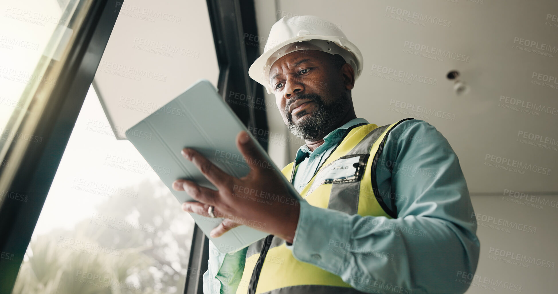 Buy stock photo Tablet, black man and construction worker on site with research for building development. Technology, email and mature civil engineer with feedback for renovation, repairs or maintenance from below.