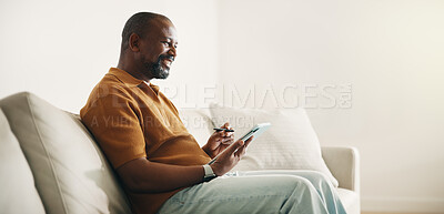 Buy stock photo Relax, tablet and writing with black man on sofa in home living room for break, browsing or space. App, pen and social media with mature person in apartment for weekend planning, research or schedule