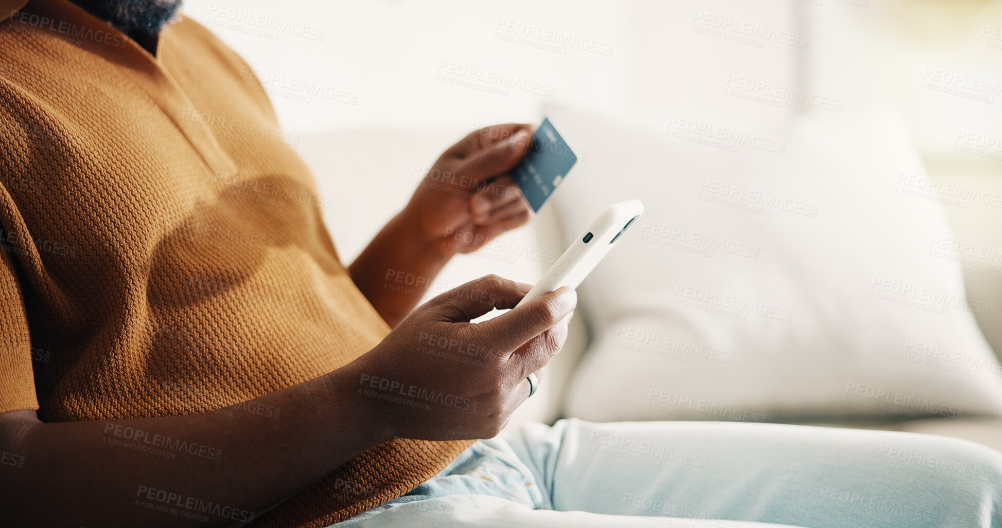 Buy stock photo Credit card, hands and phone with man on sofa in home living room for online shopping. App, ecommerce and financial transaction with person in apartment for mobile order, payment or purchase