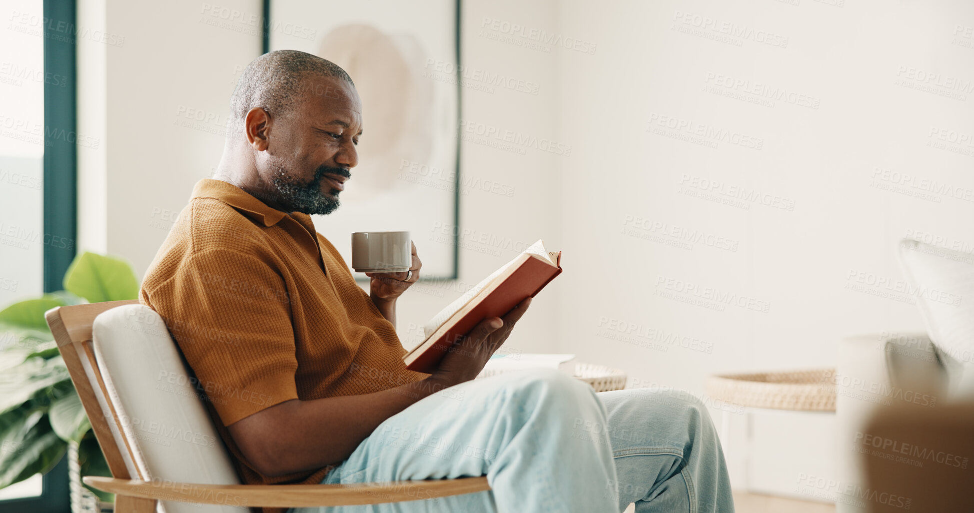 Buy stock photo Coffee, reading and relax with black man on chair in home living room for fiction, novel or space. Book, drink and literature with mature person in apartment for me time, story or weekend hobby