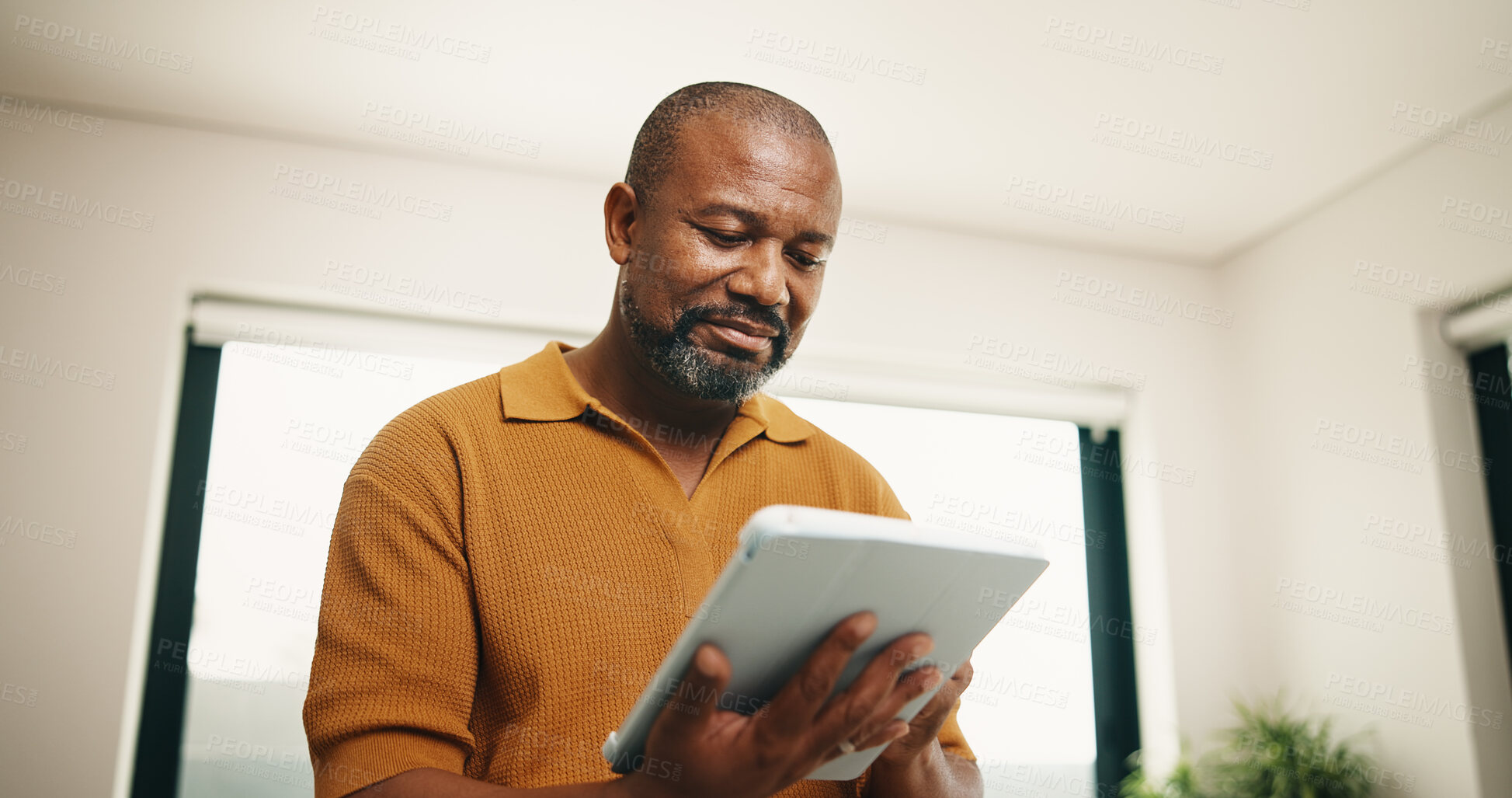 Buy stock photo Research, home and black man with tablet for online browsing, network connection or internet. Mature, male person or smile with technology, checklist or website for software, update or app in house