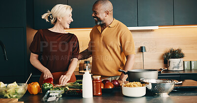 Buy stock photo Cooking, support or interracial couple in house with love, bonding activity or connection in meal prep. Smile, care or mature people with food, happy moment or culinary hobby in healthy relationship.