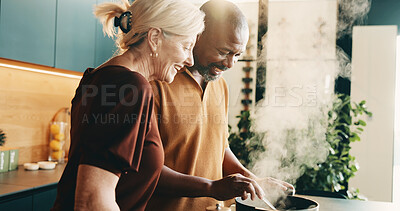 Buy stock photo Cooking, help or couple in kitchen with love, bonding activity or connection with meal prep. Smile, support or mature people in home with food, happy or culinary hobby in interracial relationship.