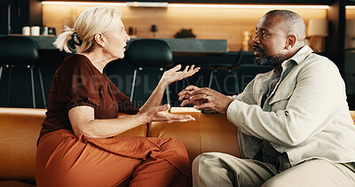 Buy stock photo Upset, fighting and couple on sofa in home with conflict, disagreement or divorce in living room. Talking, toxic marriage and mature man with woman for separation, breakup or dispute in apartment.