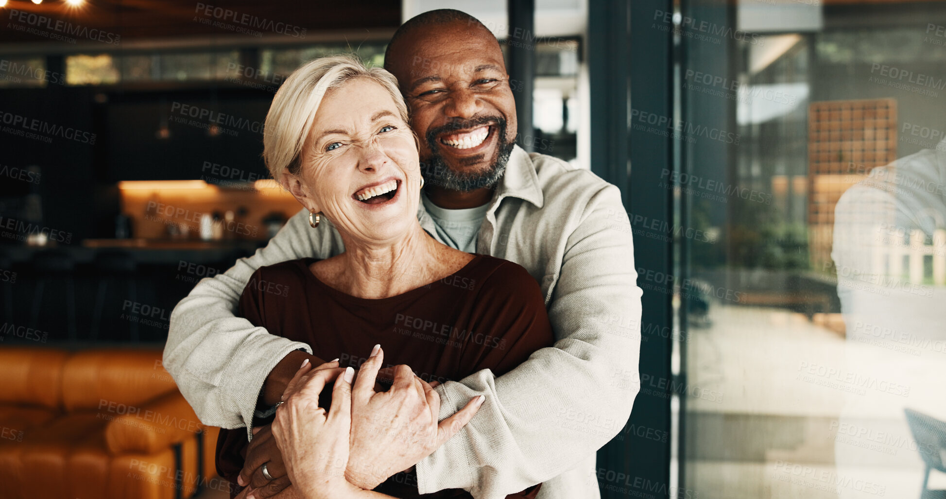 Buy stock photo Portrait, laugh or interracial couple in home with love, partner care or bonding on weekend break. Smile, trust or mature people with hug, happy moment or romantic connection in healthy relationship
