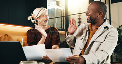 Buy stock photo Mature, couple and high five in home with documents, administration and savings for utility bills. Happy, interracial marriage and people in house with paperwork, taxes or financial relief for costs.
