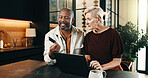 Interracial couple, laptop and conversation with credit card in home for mortgage, bills or investment. Mature man, woman and ecommerce with tech for financial planning, budget expenses or invoices