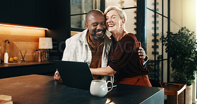 Buy stock photo Hug, laptop and online booking of holiday with interracial couple in home kitchen for vacation planning. Computer, love and smile with mature people in apartment for reservation of accommodation