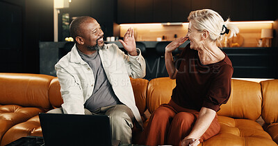 Buy stock photo Interracial couple, laptop and smile with high five in home for mortgage, bills or investment. Mature man, woman and celebration with tech for financial planning, budget expenses or loan together