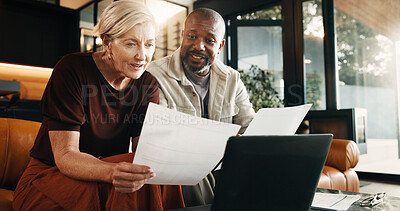 Buy stock photo Interracial couple, laptop and reading with documents in home for finance, bills or investment. Mature man, woman and paperwork with tech for financial planning, budget expenses or invoices together