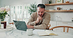 Mature, finance and man in home with laptop for budget planning, report or expenses in kitchen. Male person, reading and computer with book for financial review, tax assessment or bills in house