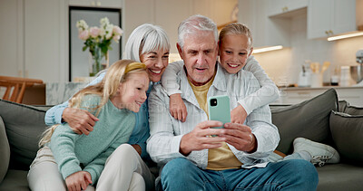 Buy stock photo Selfie, relax and grandparents with children on sofa in home for love, social media post and digital memory. Photography, support and visit with senior man and woman with kids in living room in house