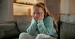 Sad, child and thinking in home with loneliness, boredom and mental health crisis in lounge. Thoughts, emotional and kid with depression, overthinking and sorrow expression for bad memories on couch