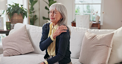 Buy stock photo Senior, woman and discomfort with shoulder pain on sofa for fibromyalgia, arthritis and strain. Retirement, pensioner and muscle tension in house for pinched nerve, health issue and joint stiffness
