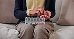 Woman, hands and pills with container on sofa for home medication, prescription or daily dosage. Female person, patient or sorting tablets for weekly pharmaceuticals, medical diagnosis or treatment
