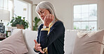 Senior, woman and elbow pain in home with discomfort, nerve compression and osteoarthritis. Retirement, pensioner and joint inflammation in living room with tendon ache, muscle tension and massage