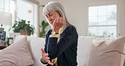 Buy stock photo Senior, woman and elbow pain in home with discomfort, nerve compression and osteoarthritis. Retirement, pensioner and joint inflammation in living room with tendon ache, muscle tension and massage