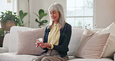 Buy stock photo Senior, woman and pills with container in home for medical cure, recovery or treatment on sofa. Elderly, female person or patient with smile or tablets for health symptoms or side effects in house
