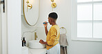 Dental health, back and black child brushing teeth in bathroom for hygiene, wellness or morning. Toothbrush, oral care and boy kid with cleaning mouth for fresh breath or grooming routine in house.