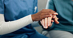 Nursing home, caregiver and holding hands with old person, empathy or support with gesture in lounge. Assisted living, nurse and comfort for elderly patient, kindness and healthcare services in house