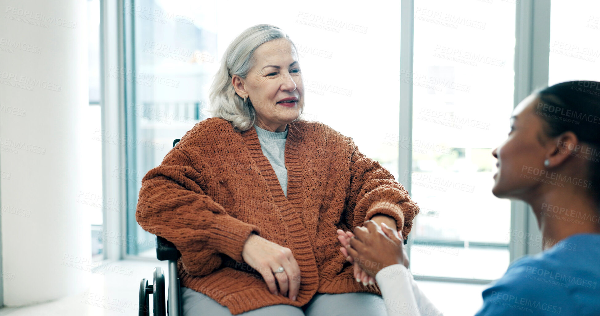 Buy stock photo Happy, caregiver and holding hands with old woman in wheelchair, clinic and helping elderly patient. Nurse, consultation and senior person with disability, support and healthcare services in hospital