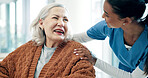Trust, caregiver and senior woman in home for assisted living, laughing and healthcare service. Smile, comfort and elderly person with nurse in house for support, medical advice or joke in retirement