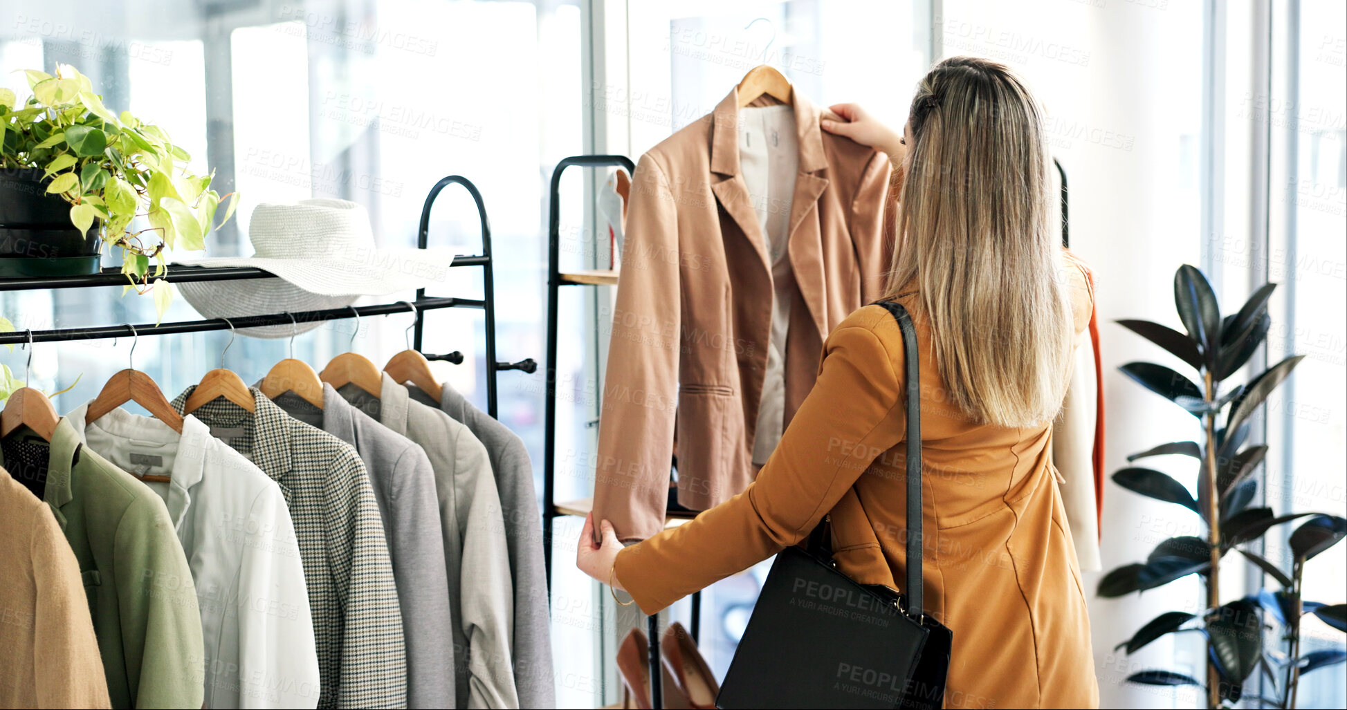 Buy stock photo Back, clothes and woman in store, choice and shopping with retail therapy, options and fashion. Customer, luxury design and person in boutique, discount deal and sale for product and rack with fabric