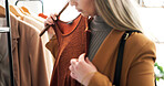 Fashion, clothes and woman in store, choice and shopping with options, fabric and customer. Consumer, luxury design and person in boutique, discount deal and sale for product, client and inspection