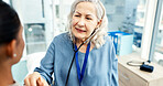 Doctor, patient and stethoscope in office with consultation, heart assessment and disease detection. Healthcare worker, people and cardiology equipment in clinic with chest exam, medical test or help