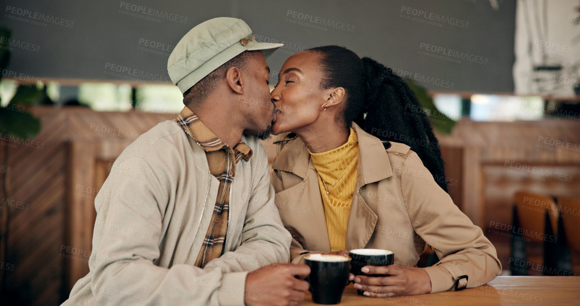 Buy stock photo Couple, date and coffee at cafe with kiss, love and partner affection for bonding together. Black people, romance and care at restaurant with drink, healthy relationship and connection for commitment