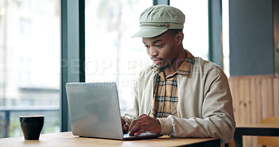 Buy stock photo Laptop, typing and black man in cafe for research on creative project with freelance career. Computer, reading and African male magazine editor with online article for publishing in coffee shop.