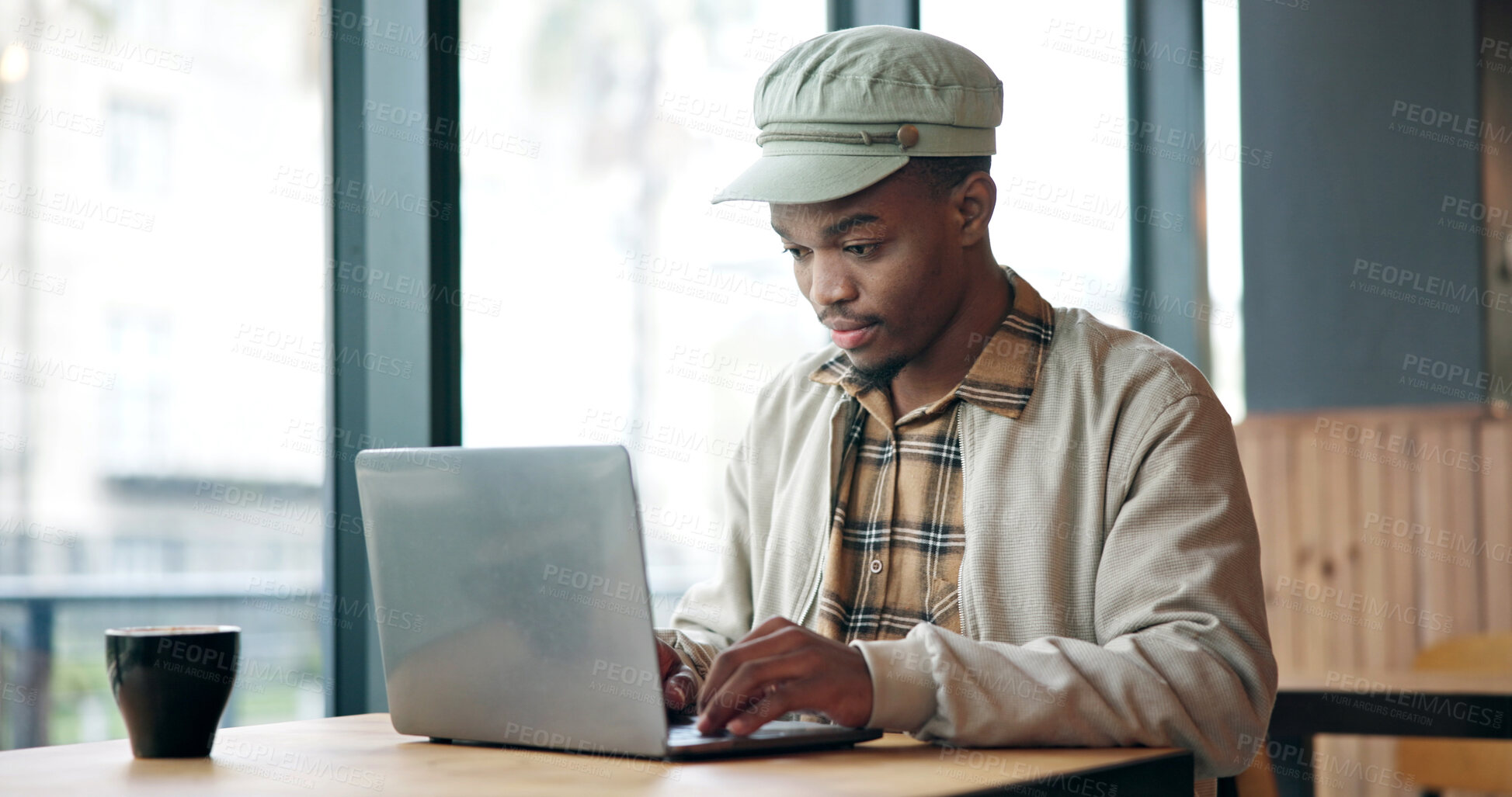 Buy stock photo Laptop, typing and black man in cafe for research on creative project with freelance career. Computer, reading and African male magazine editor with online article for publishing in coffee shop.