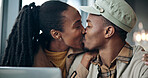 Happy, laptop and black couple with kiss in cafe for romance, date or affection together. Man, woman or intimacy with love, care or smile for commitment, passion or romantic embrace in coffee shop
