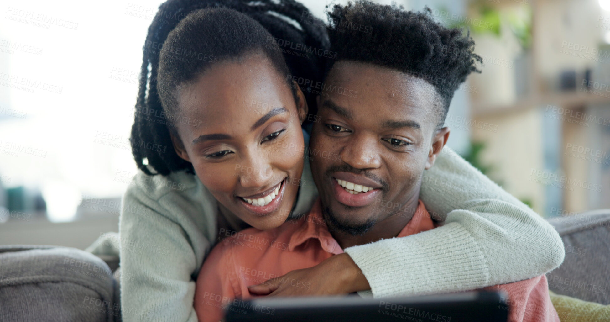 Buy stock photo Couple, hug and relax with tablet in lounge, entertainment and streaming film with app subscription. Black people, online and happy with partner on couch, bonding and watching movie with tech in home