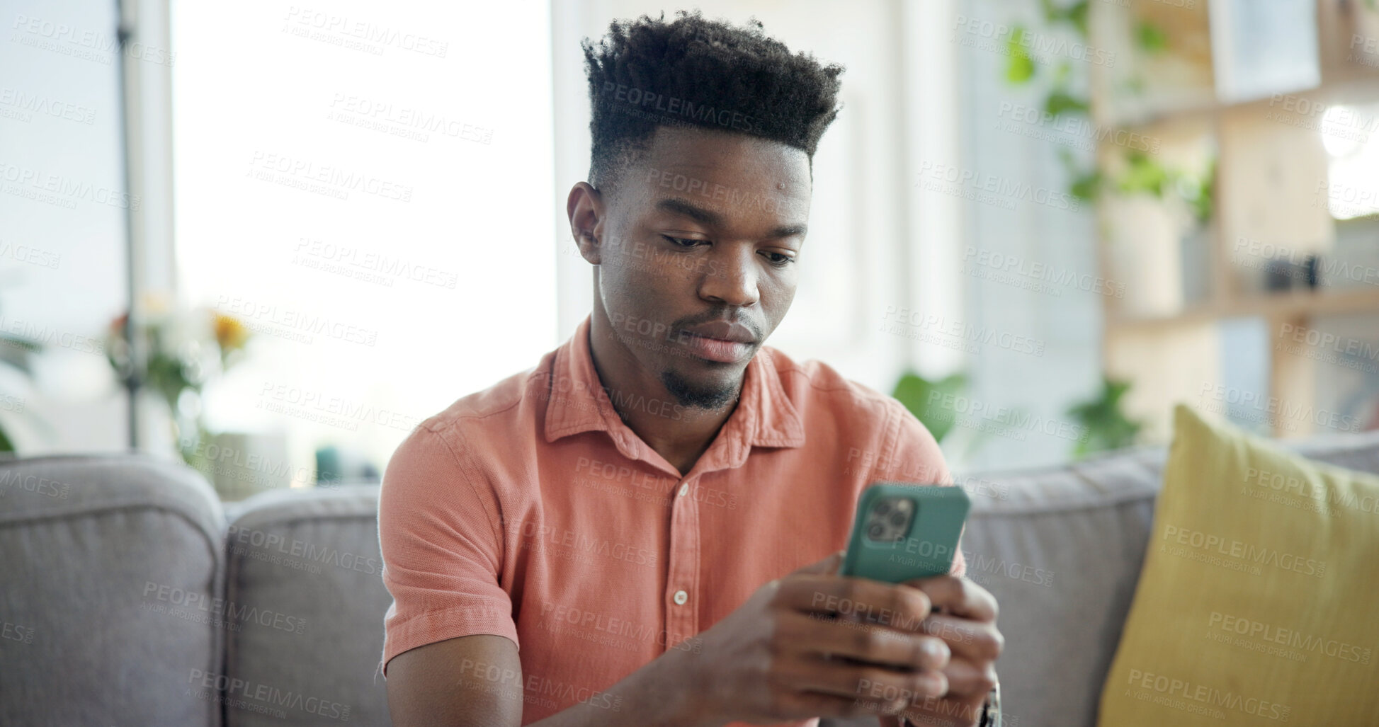 Buy stock photo Texting, phone and black man on sofa in home with networking, connection or chatting on mobile app. Relax, technology and African person with cellphone for research, communication or social media.