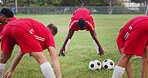 Athlete, players and stretching on field for soccer, fitness and match practice for competition. People, warm up and ball at park for football, exercise and training for sports tournament with team
