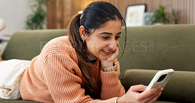Buy stock photo Happy, reading and woman on sofa with phone, online conversation and message notification on weekend. Home, smile and person relax with cellphone for internet, website and social media in living room