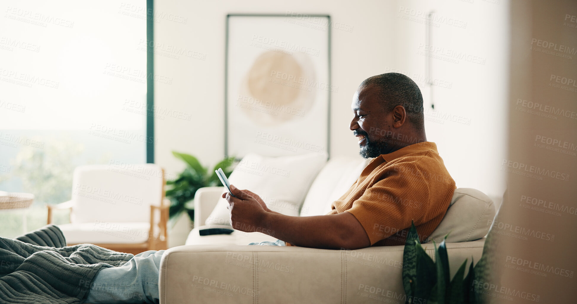 Buy stock photo Happy, relax and black man with tablet on sofa for entertainment or online subscription in home. Male person, chilling and smile with technology on couch for movie, series or streaming app in house